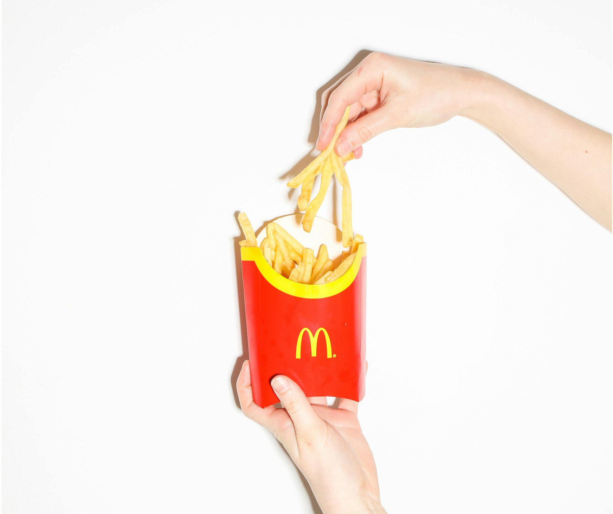 hand reaching for McDonalds fries