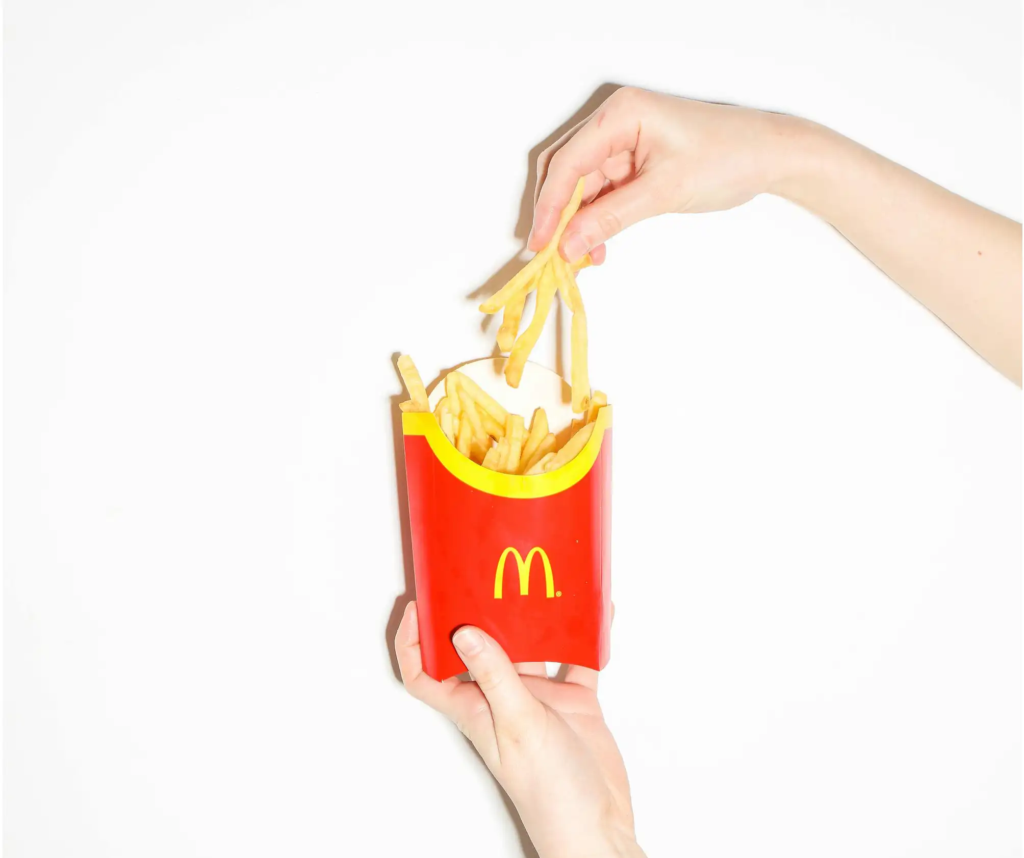 hand reaching for McDonalds fries