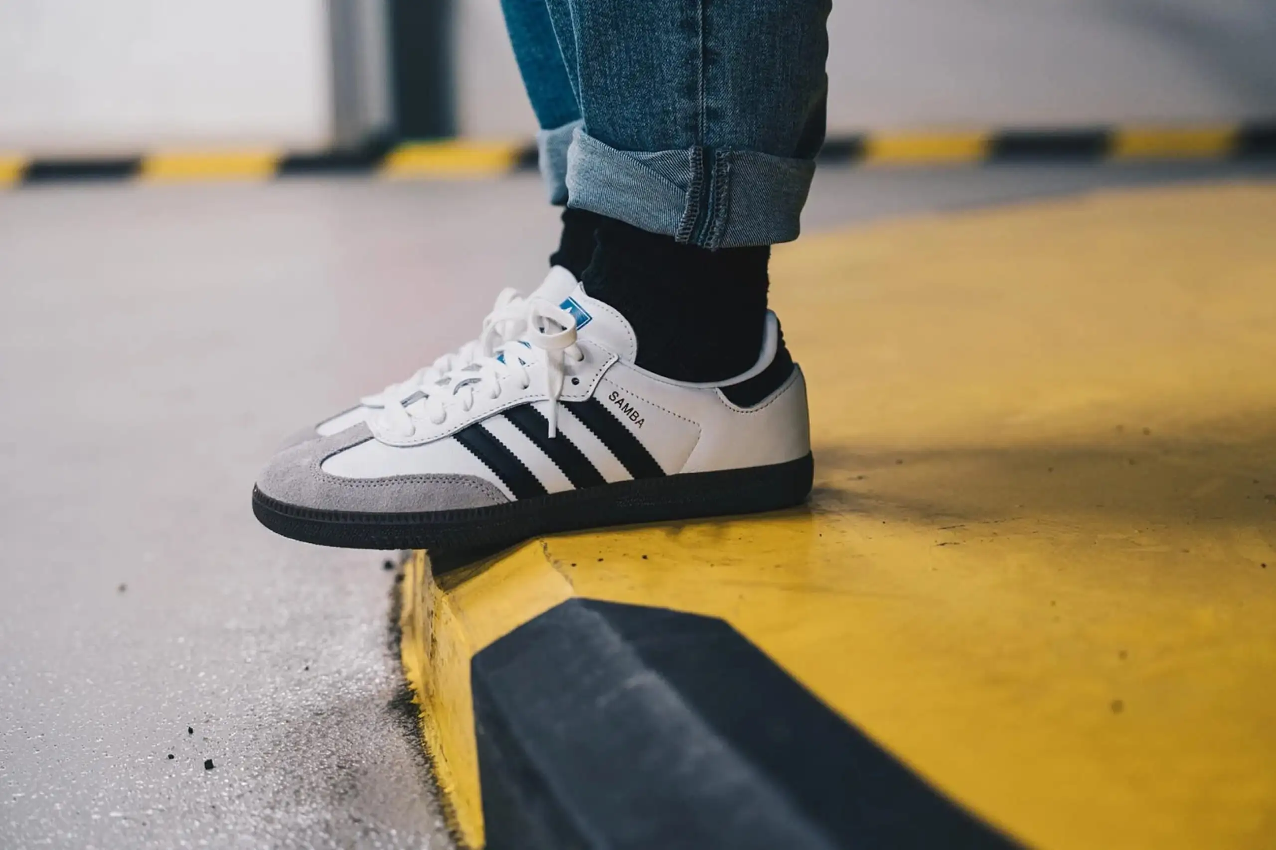 Someone wearing white Adidas Samba sneakers | The Brief Someone wearing white Adidas Samba sneakers | The Brief